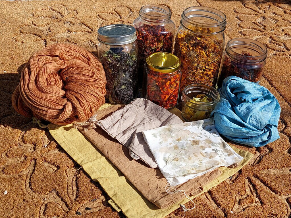 Yarn, fabrics and jars full of dried flowers
