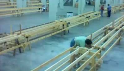 Volunteers working to put together long wooden tables