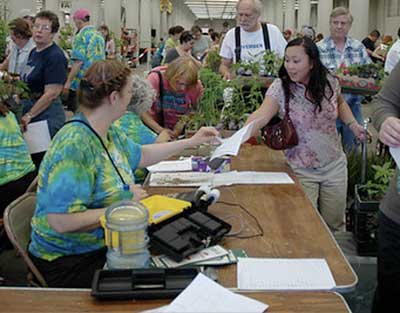 Volunteers at a table, customer paying
