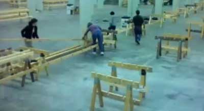 Volunteers working to take apart tables